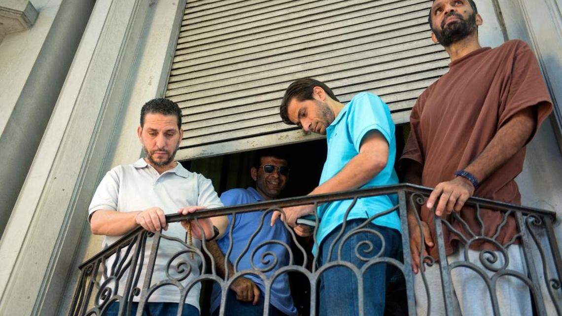 Freed Guantánamo captives, from left, Adel bin Muhammad El Ouerghi from Tunisia, Ali Husain Shaaban from Syria, Ahmed Adnan Ajuri from Syria, and Palestinian Mohammed Abdullah Taha Mattan stand on a balcony of their temporary home in Montevideo, Uruguay, in 2014.