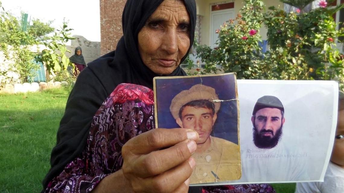 On Tuesday, Aug. 16, 2016 the mother of recently released detainee Obaidullah holds pictures of her son at her home in the village of Haiderkhil, Mandozai district of Khost province, Afghanistan. Obaidullah’s family said they’re excited their son is among 15 prisoners released from Guantánamo and transferred to the United Arab Emirates this week. They say Obaidullah is now “free” after 14 years in the U.S. prison in Cuba and that they can hardly wait to hear from him.