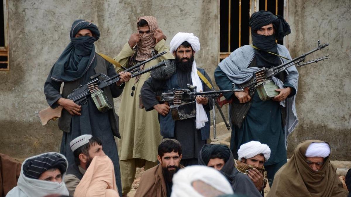 In this Nov. 3, 2015 file photo, Afghan Taliban fighters listen to Mullah Mohammed Rasool, the newly-elected leader of a breakaway faction of the Taliban, in Farah province, Afghanistan. Senior members of the Afghan Taliban said on Thursday that a prominent figure within the militant group who had opposed its new leadership has now pledged his allegiance, helping to close divisions within the Taliban ahead of possible peace talks with the government.
