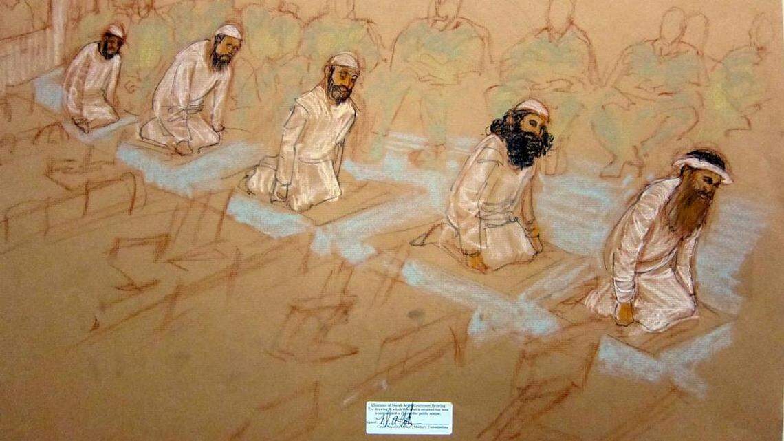 Left to right: Mustafa al Hawsawi, Ammar al Baluchi, Ramzi bin al Shibh, Walid Bin Attash and Khalik Sheik Mohammad, pray at their Guantánamo war court arraignment Saturday, May 5, 2012. Sketch reviewed and approved for release by a U.S. military security official.