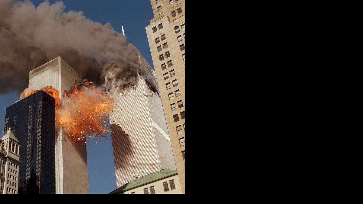 
Smoke billows from one of the towers of the World Trade Center and flames and debris explode from the second tower on Tuesday, Sept. 11, 2001.
