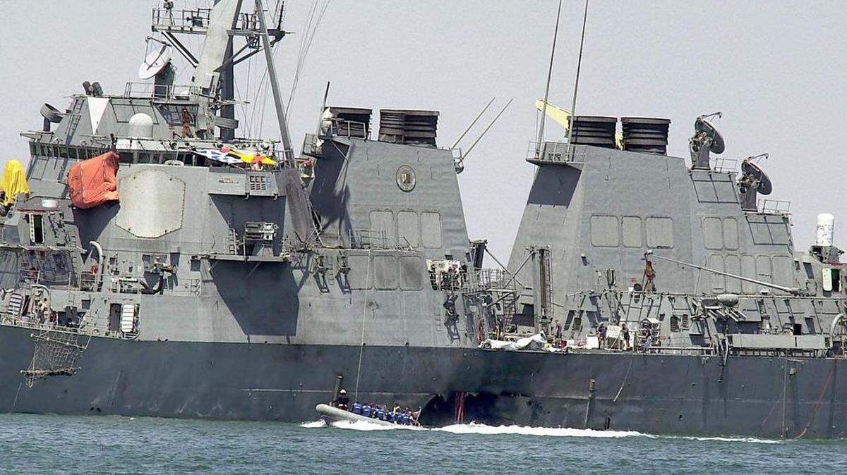 This Oct. 15, 2000 file photo shows investigators in a speed boat examining the hull of the USS Cole at the Yemeni port of Aden, after a powerful explosion ripped a hole in the U.S Navy destroyer.