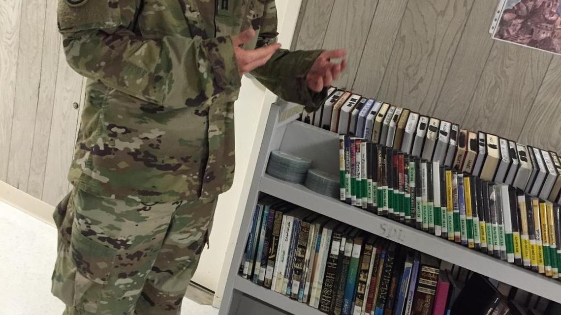 The official title of the Army captain known as ‘The Librarian’ is Officer-in-Charge of Detainee Programs for the 65 low-value detainees at Guantánamo. On May 24, 2016, he briefed reporters in a trailer housing much of the collection, on condition his face not be photographed. This image was approved for release by the detention center media relations team.