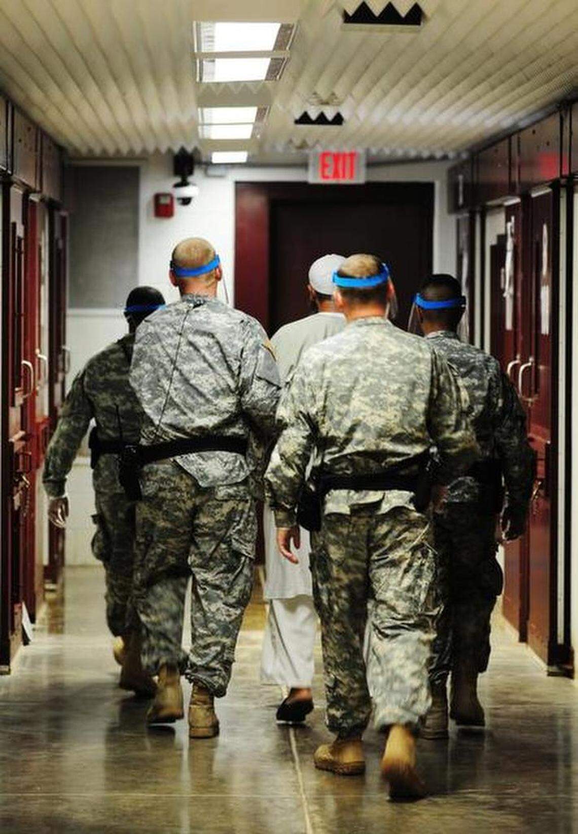 Army guards move a captive from his cell in Camp 5 on Oct. 18, 2011 in a U.S. military photo released by the U.S. Navy base at Guantanamo Bay, Cuba.
