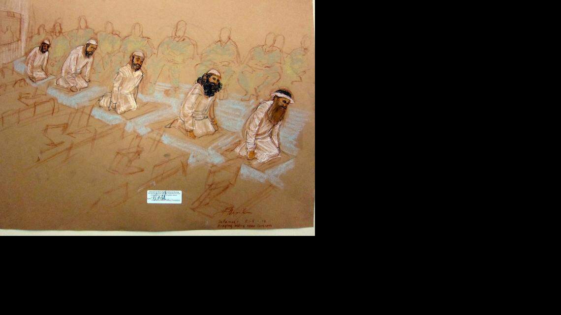 
The accused Sept. 11 conspirators unfurled their prayer rugs during scheduled prayer breaks at their May 5, 2012 arraignment at the U.S. Navy base at Guantanamo. They are, from, Mustafa al Hawsawi, Ammar al Baluchi, Ramzi bin al Shibh, Walid Bin Attash,and Khalid Sheik Mohammad, shown in this sketch reviewed and approved for release by a U.S. military security official at the base.
