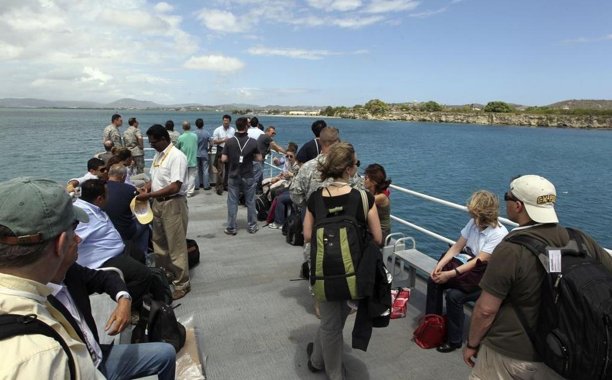 Journalists aboard a U.S. Navy ferry crossing Guantánamo Bay on May 4, 2012, the eve of the arraignment of Khalid Sheik Mohammed and four alleged accomplices in the Sept. 11 terror attacks.