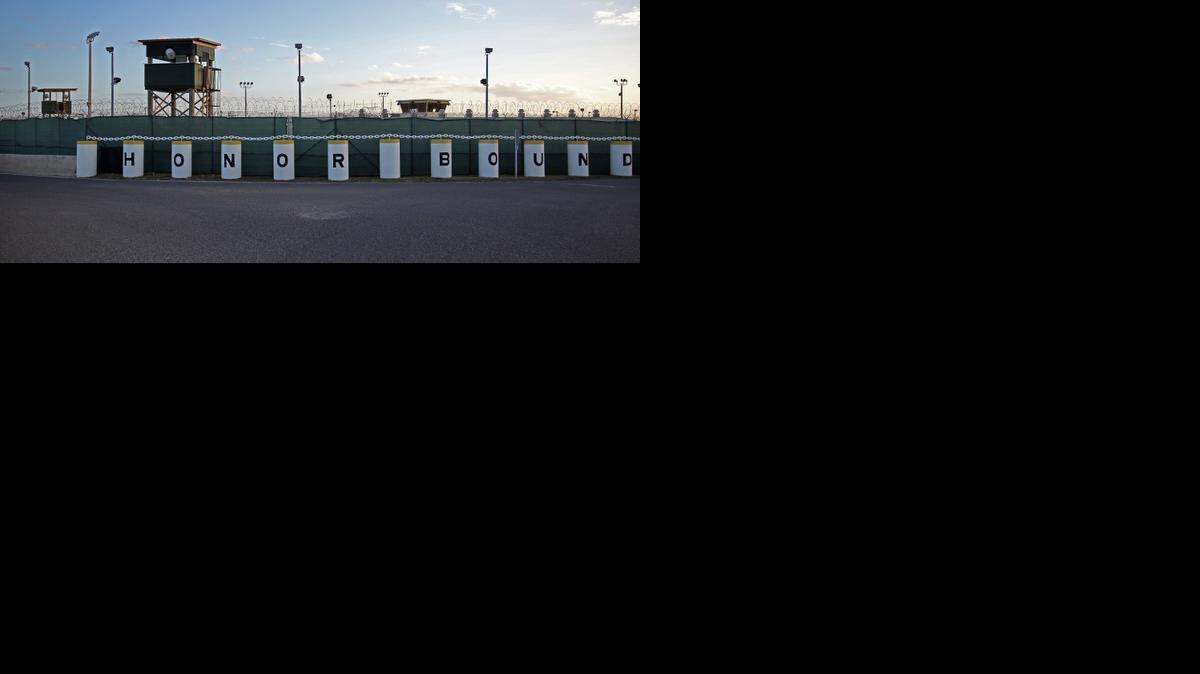 
The main road in the Detention Center Zone shows an unused prison camp and the detainee hospital and psychiatric ward behind an “Honor Bound” sign at U.S. Navy base at Guantánamo Bay, Cuba, on Tuesday, Nov. 4, 2014 in this photo approved for release by the U.S. military.
