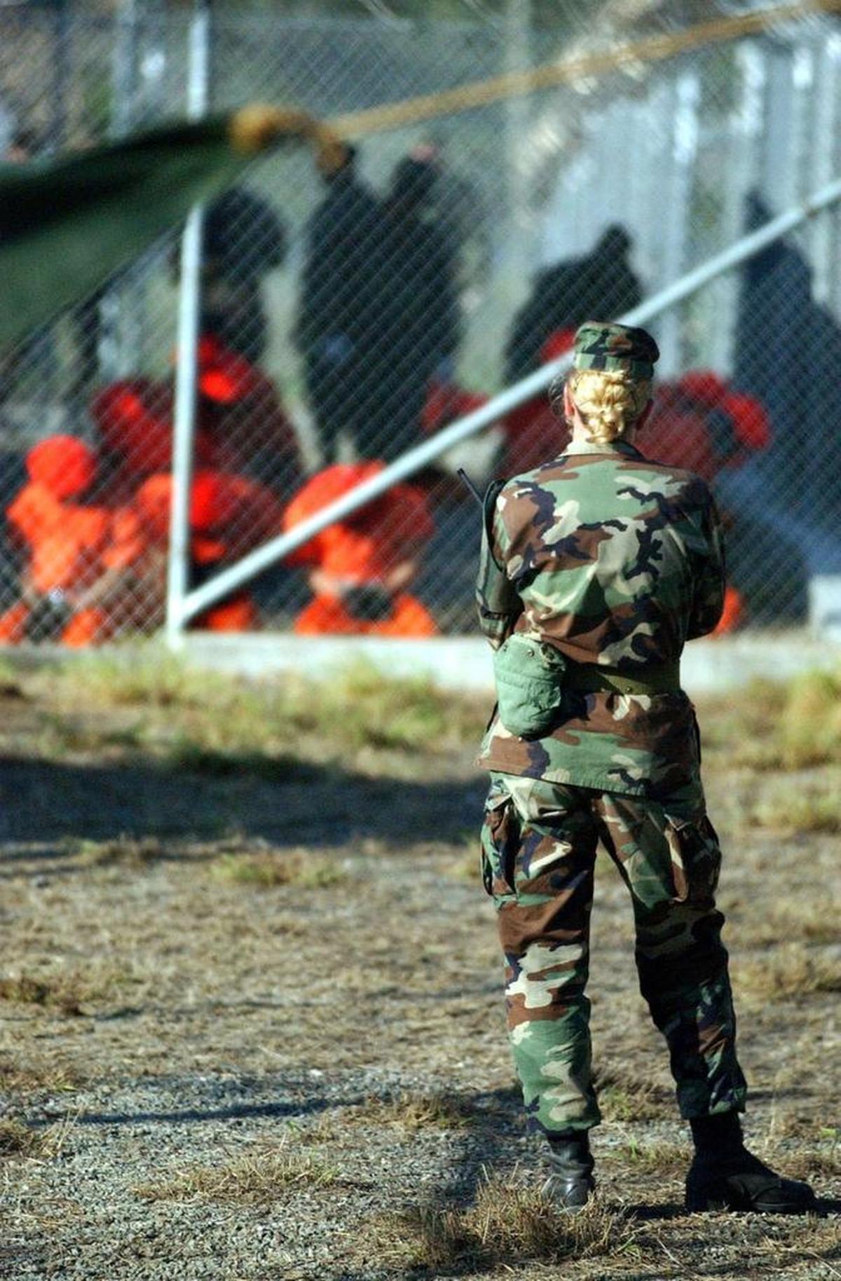 U.S. Army Private First Class Jodi Smith, an MP, stands perimeter watch at Camp X-Ray the day the first detainees arrived, Jan. 11, 2002 in this Pentagon handout photo.