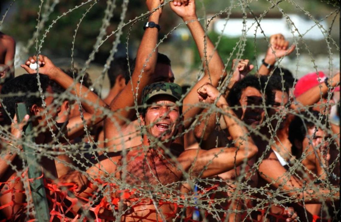 A Miami Herald file photo from the U.S. Navy base at Guantánamo Bay, Cuba, where Cubans interdicted at sea on their way to Florida shouted, “Liberty, Liberty” from inside a migrant tent camp on Sept. 2, 1994.