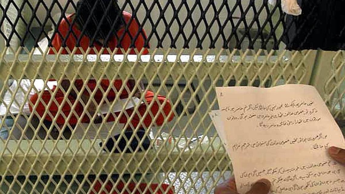 This Pentagon handout photo dated July 13, 2004 shows a Guantánamo captive listening to an unidentified person read a notice of his coming Combatant Status Review Tribunal. The Pentagon also said it notified all 594 captives at the prison that they could use the U.S. courts to contest their detention as well as challenge their status as “enemy combatants” before a military panel. A 2005 Pentagon document, released to the Miami Herald in December 2015, said the U.S. spent $1,080,952.54 on the so-called CSRT program in 2004 and budgeted $4,167,920 for 2005.