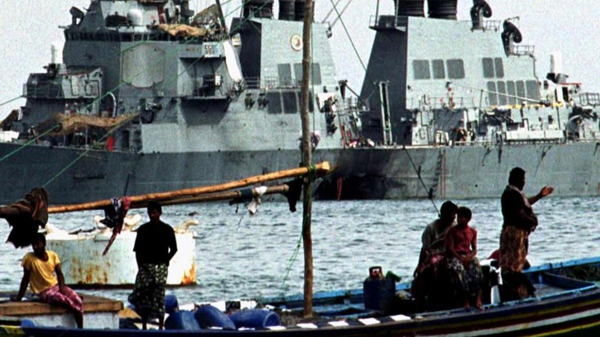 Yemeni fishermen pass by the damaged USS Cole in Aden in this file photo dated Oct. 28, 2000.