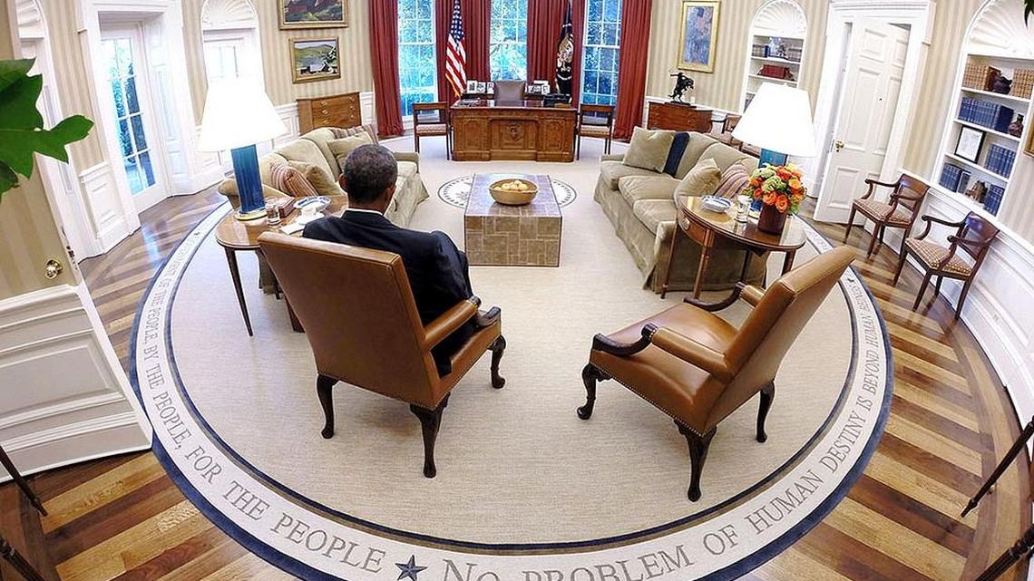 
President Barack Obama reads briefing material before the Presidential Daily Briefing in the Oval Office Aug. 29, 2014 in this official White House photo.

