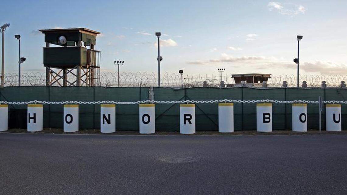 The main road in the Detention Center Zone shows an unused prison camp and the detainee hospital and psychiatric ward behind an “Honor Bound” sign at U.S. Navy base at Guantánamo Bay, Cuba, on Tuesday, Nov. 4, 2014 in this photo approved for release by the U.S. military.