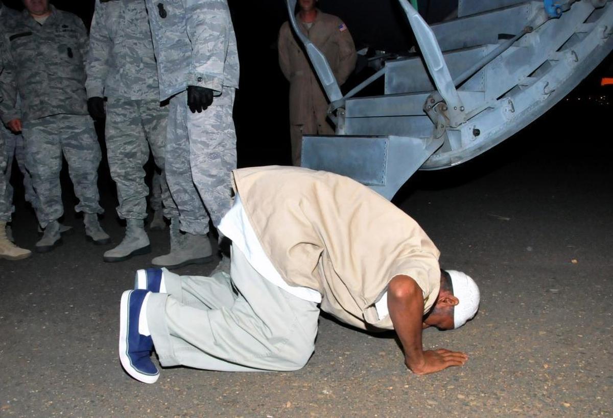 Sudanese national, Ibrahim al Qosi, in his 50s, a former al-Qaida cook released from Guantánamo, prays upon arrival at Khartoum airport in Sudan, Wednesday, July 11, 2012. Qosi arrived before dawn on a U.S. Air Force aircraft after his release from 10 years in detention.