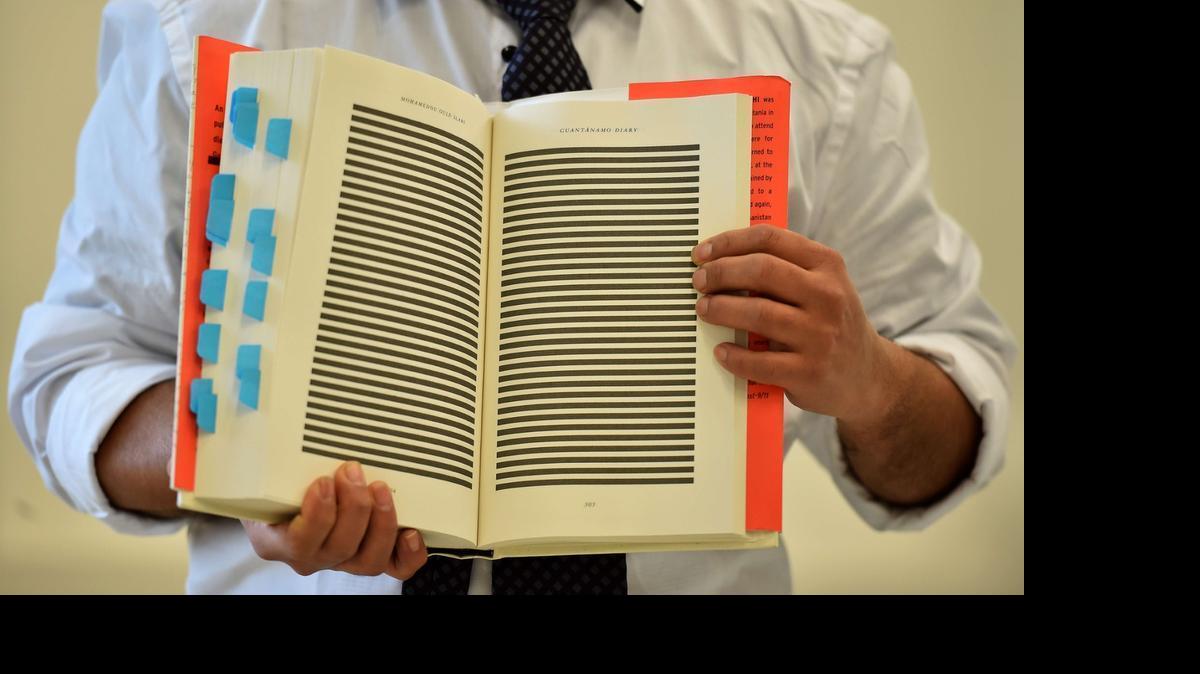 
The younger brother of Mohamedou Ould Slahi, Yahdih Ould Slahi, with a copy of Mohamedou’s prison memoir in London on Jan. 20, 2015 showing pages that were redacted by the U.S. government.

