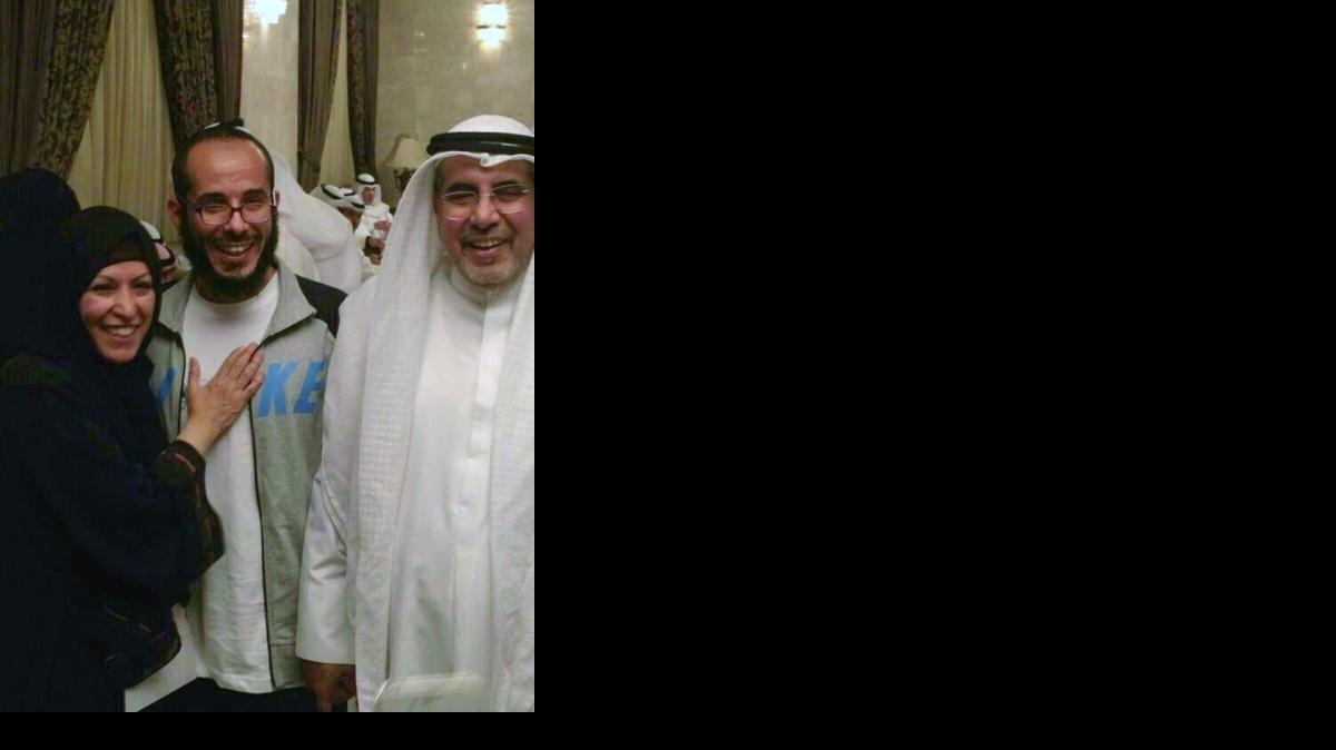 
A handout picture released by the family shows Fawzi al Odah, center, posing with his father and a relative as he was welcomed at a military hospital in Kuwait City upon his arrival in the Gulf state on Nov. 6, 2014 — the same day he was released from Guantánamo after nearly 13 years in U.S. custody. After a week, Fawzi al Odah will be transferred to a government-run rehabilitation center for an unspecified period but his close relatives will be allowed to visit him, according to AFP/Getty Images, which provided the image. 
