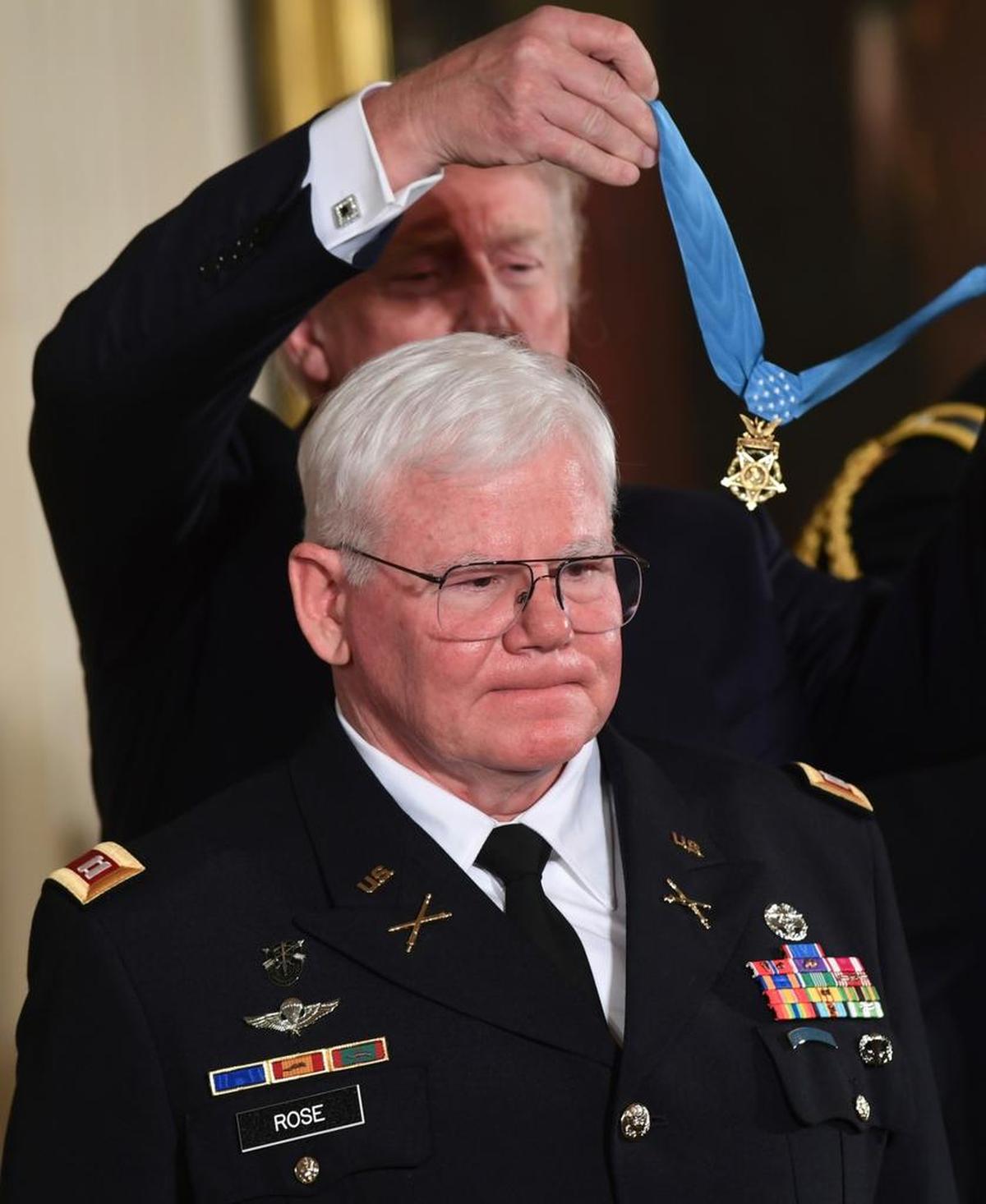President Donald Trump bestows the nation's highest military honor, the Medal of Honor, to retired Army Capt. Gary M. Rose during a ceremony in the East Room of the White House in Washington, Monday, Oct. 23, 2017.