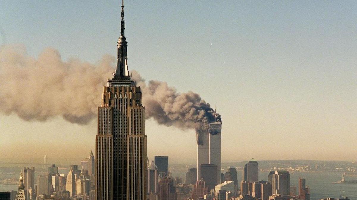 The twin towers of the World Trade Center burn behind the Empire State Building on Sept. 11, 2001.