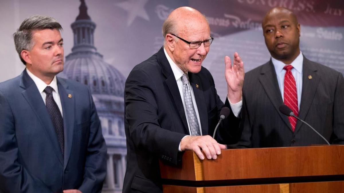Sen. Pat Roberts, R-Kansas., center, with Sen. Cory Gardner, R-Colo., left, and Sen. Tim Scott, R-S.C., speak to reporters about Guantánamo Bay Detention Facility, Nov. 5, 2015, during a news conference on Capitol Hill in Washington. The House on Thursday overwhelmingly passed a revised $607 billion defense policy bill that restricts President Barack Obama's efforts to close the military prison at Guantánamo Bay, Cuba.