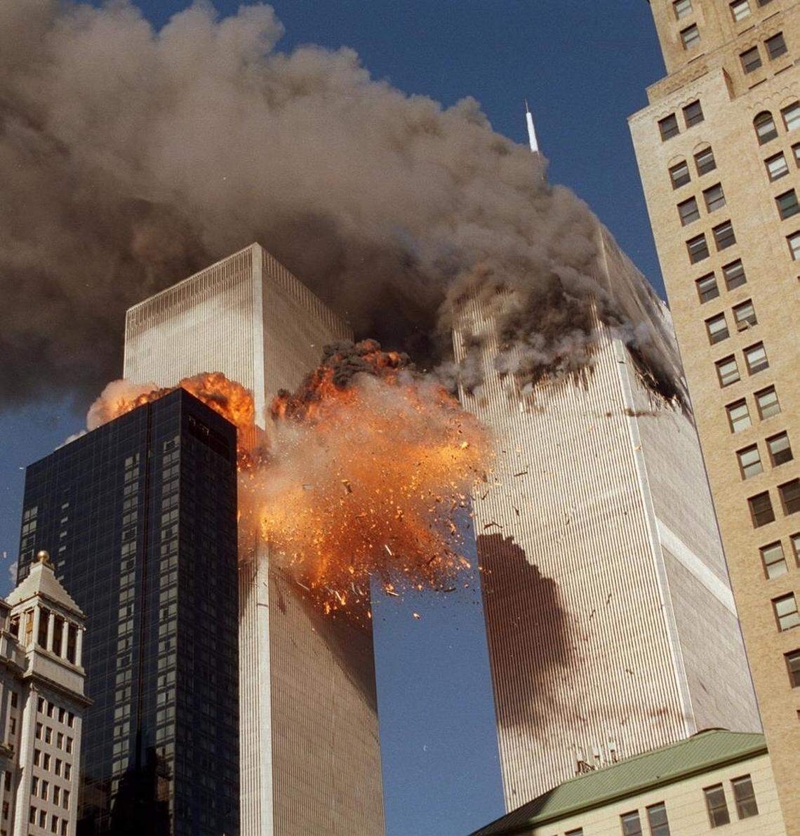 Smoke billows from one of the towers of the World Trade Center and flames and debris explode from the second tower, Tuesday, Sept. 11, 2001.