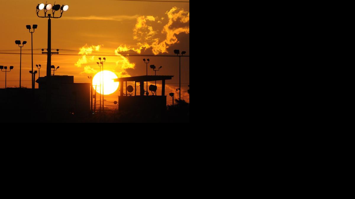 
In this Oct. 18, 2012 file photo reviewed by the U.S. Department of Defense, towers overlooking a U.S. detention facility are silhouetted against a morning sunrise at Guantánamo Bay U.S. Navy Base, Cuba. 

