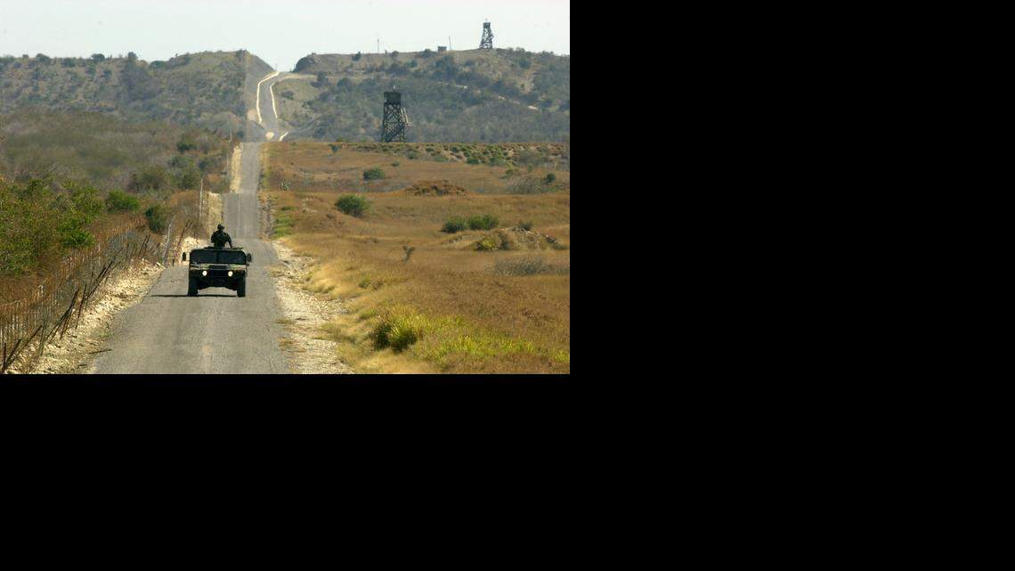 
ISOLATED LAND: A U.S. Marines Humvee patrols the fence line that divides the U.S. Navy base at Guantánamo Bay, Cuba.  
