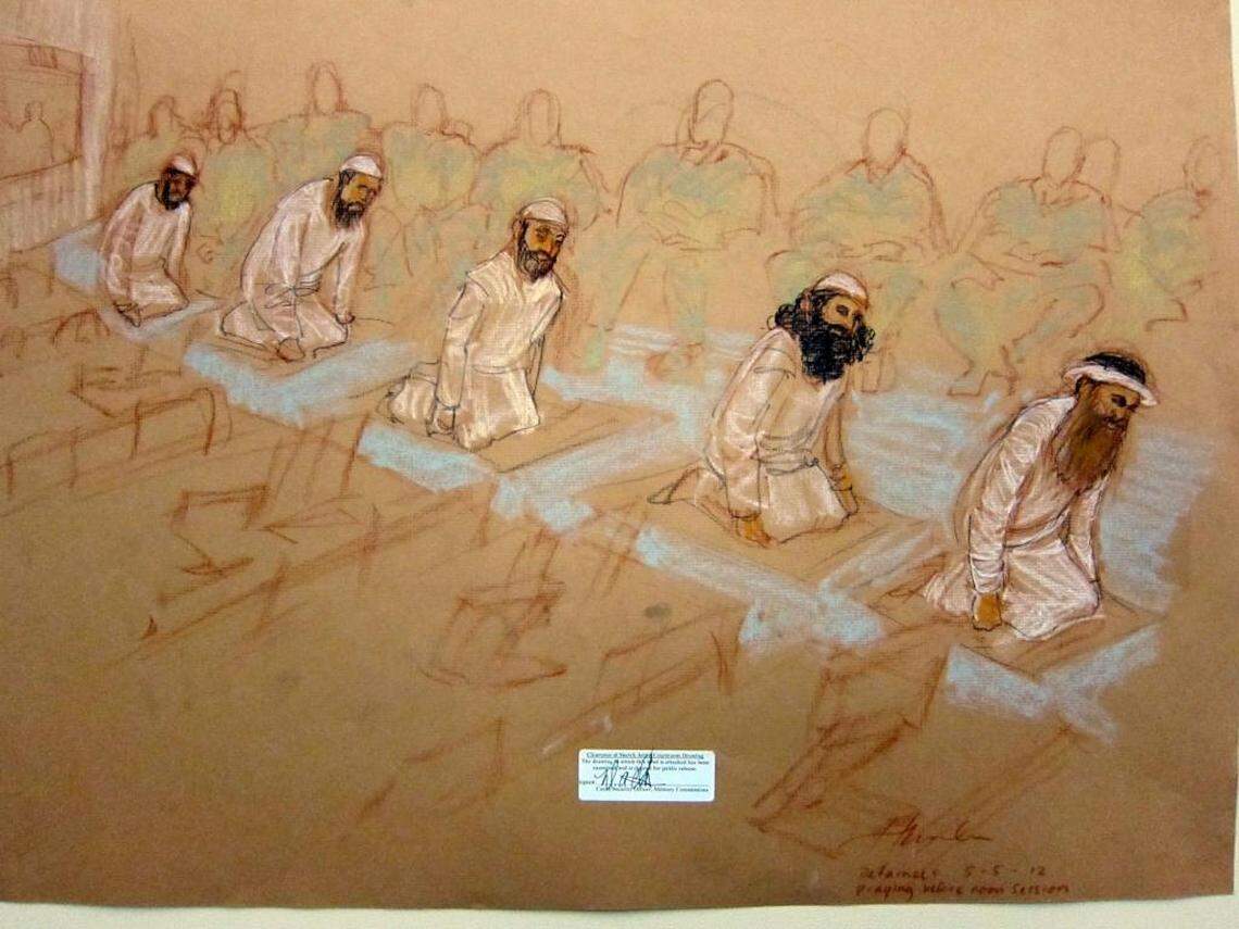 From left, Mustafa al Hawsawi, Ammar al Baluchi, Ramzi bin al Shibh, Walid bin Attash and Khalid Sheik Mohammed pray at their Guantánamo war court arraignment on May 5, 2012. This sketch was reviewed and approved for release by a U.S. military security official.