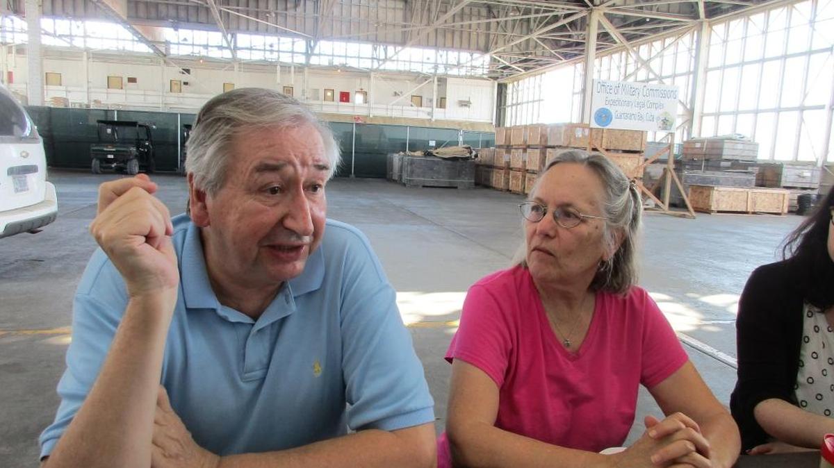 John Olson, a lawyer from Rockville Centre, New York, whose wife, Maureen, was killed in the World Trade Center on Sept. 11, 2001, speaks to reporters at the U.S. Navy base at Guantánamo Bay, Cuba on Dec. 7, 2015 during a break in a pretrial hearing for five men charged in the attack. Seated beside him is Phyllis Rodriguez, whose son Gregory was also killed at the World Trade Center.