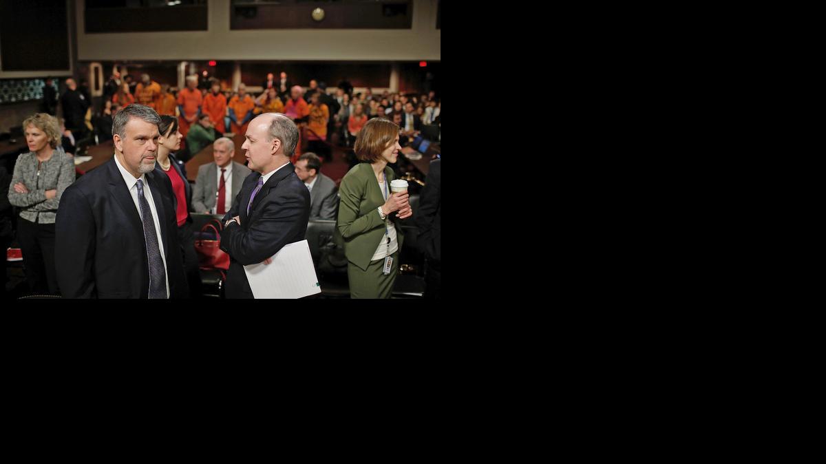
Nicholas Rasmussen, left, director of the National Counterterrorism Center, talks with Principal Deputy Defense Undersecretary for Policy Brian McKeon, right, as protesters from the group Code Pink attend a hearing about the Guantánamo detention facility by the Senate Armed Services Committee on Capitol Hill Feb. 5, 2015 in Washington, D.C.
