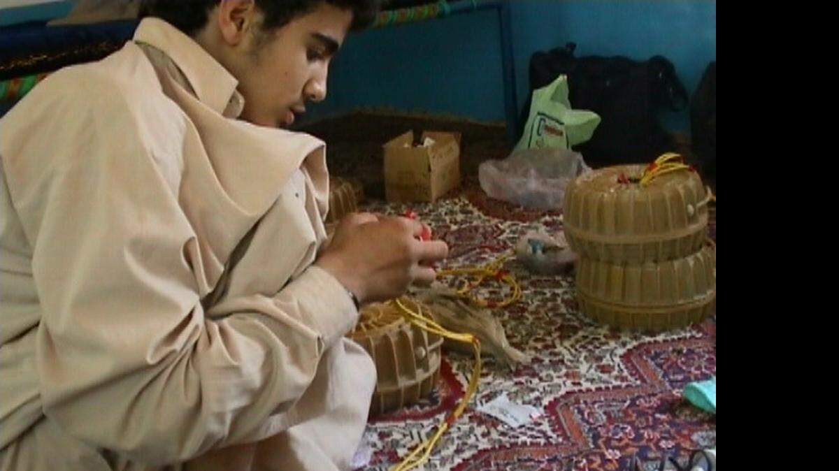 
Omar Khadr, at age 15, in the summer of 2002, learning to build land mines in Afghanistan, in a photo used as an exhibit by a war court prosecutor at the U.S. Navy base at Guantánamo Bay, Cuba. The prosecution asked a jury to sentence Khadr, now 24, to 25 years. The jury instead gave him 40 but a plea agreement limited his sentence to eight years.

