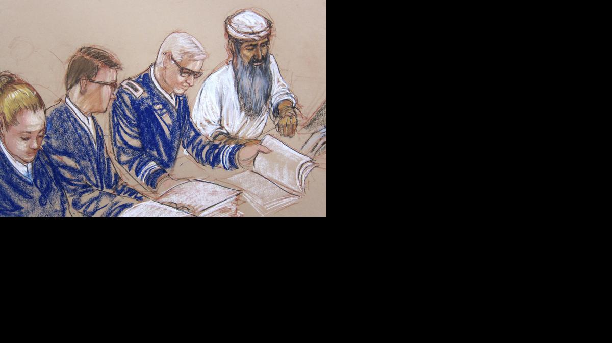 
In this Pentagon-approved sketch by court artist Janet Hamlin, Abdul al Hadi al Iraqi is arraigned on war crimes charges at the U.S. Navy Base at Guantanamo Bay, Cuba, Wednesday, June 18, 2014. Hadi, who had a long grey beard and wore a white tunic and headdress, listened calmly as the charges were listed. He did not enter a plea during the half-hour session. His defense shown from left to right, Navy Chief Jennifer Bailey, paralegal, Air Force Major Ben Stirk, and Army Lt. Col. Christopher Callen. 
