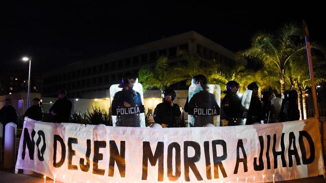 A sign that reads in Spanish “Don’t let Jihad die” hangs behind candles outside the U.S. Embassy during a demonstration in Montevideo, Uruguay, Friday, Sept. 16, 2016. Former Guantánamo detainee Abu Wa’el Dhiab from Syria, also called Jihad, is on a hunger strike, threatening to die if he is not allowed to reunite with his family elsewhere, after he was resettled in Uruguay.