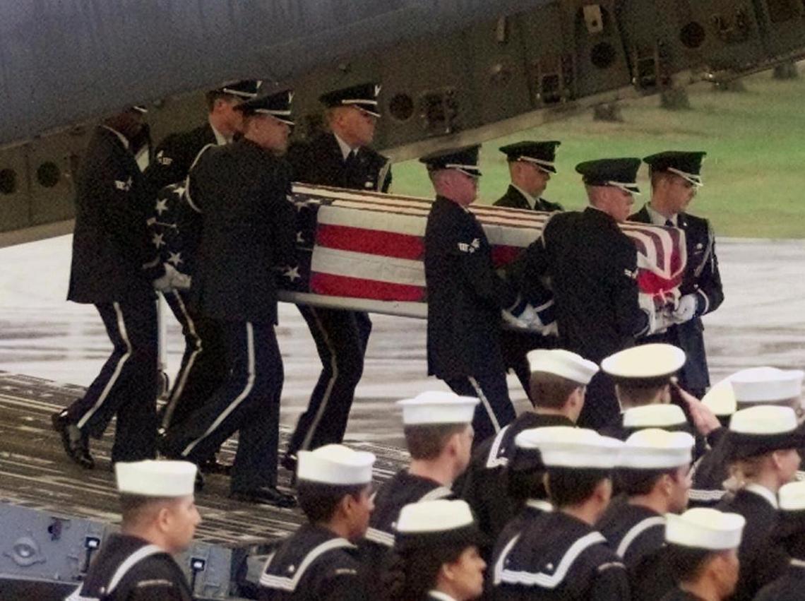 A U.S. Air Force honor guard carries the coffin of a killed sailor from a C-17 Air Force aircraft at the U.S. air base in Ramstein, Germany Friday, Oct. 13, 2000. Seventeen sailors died and 33 were injured in the explosion on the USS Cole while it was refueling in the Yemeni port of Aden.