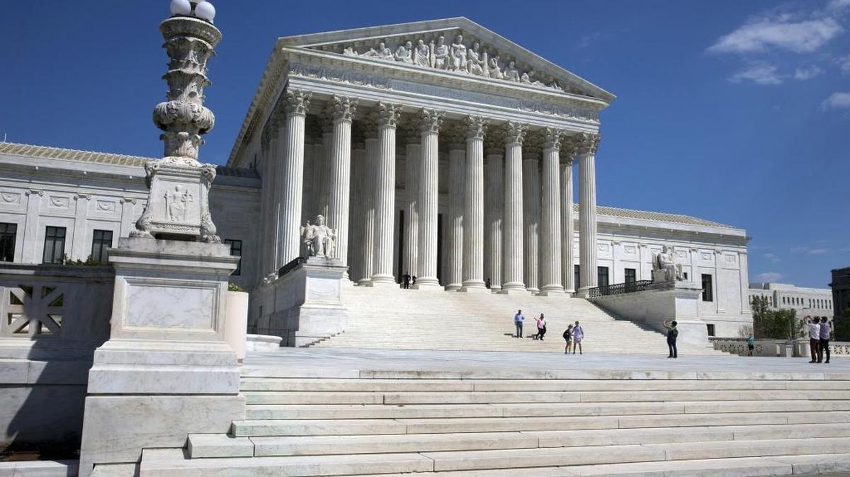In this April 26, 2014 file photo, people walk on the steps of the Supreme Court in Washington.