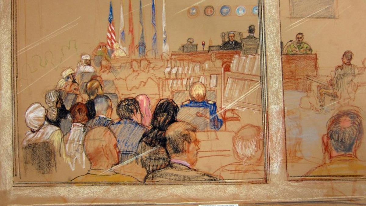 The view from the war court spectators’ gallery in a Pentagon approved sketch on Dec. 5, 2016 at 9/11 pretrial hearings at the U.S. Navy base at Guantánamo Bay, Cuba. The accused terrorists get to hear the proceedings real time; the public watches it live but listens on a 40-second delay.