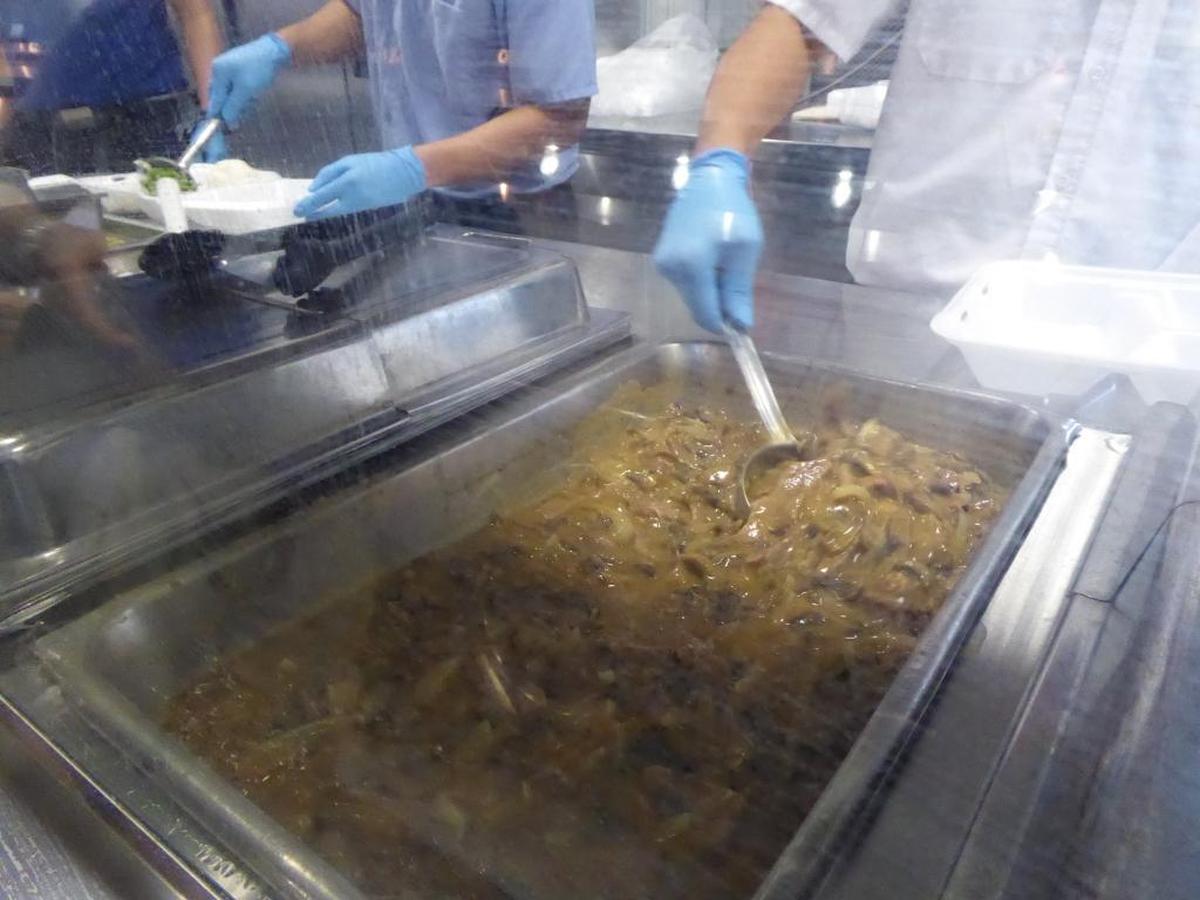 Foreign contract workers scoop beef stroganoff, rice and peas into Styrofoam containers for delivery to Guantánamo detainee cellblocks on Saturday, Feb. 3, 2017 in a photo from the Navy base Detention Center Zone approved for release by the U.S. military.
