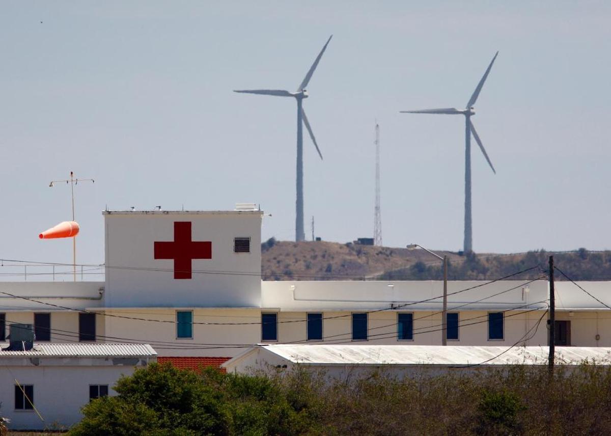 Wind turbines on John Paul Jones Hill, with the base Navy hospital in the foreground on March 29, 2009, are part of a Pentagon effort to cut the consumption of fossil fuels at the U.S. Navy base at Guantánamo Bay, Cuba.