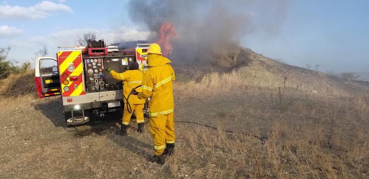 U.S. firefighters work to contain a wildfire at Guantánamo Navy base on Thursday, Feb. 22, 2018, in an image released by the U.S. Navy.