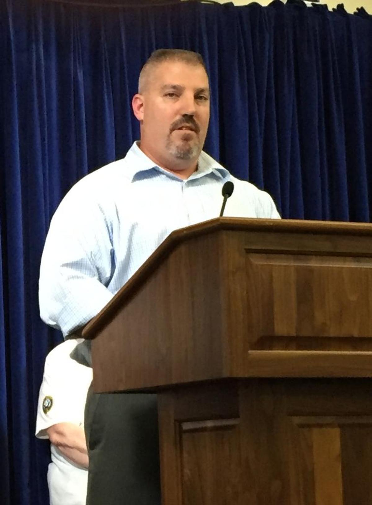 Joe Pelly, a USS Cole bombing survivor and a retired senior chief petty officer, speaks to reporters at the U.S. Navy base at Guantánamo on Sept. 9, 2016.