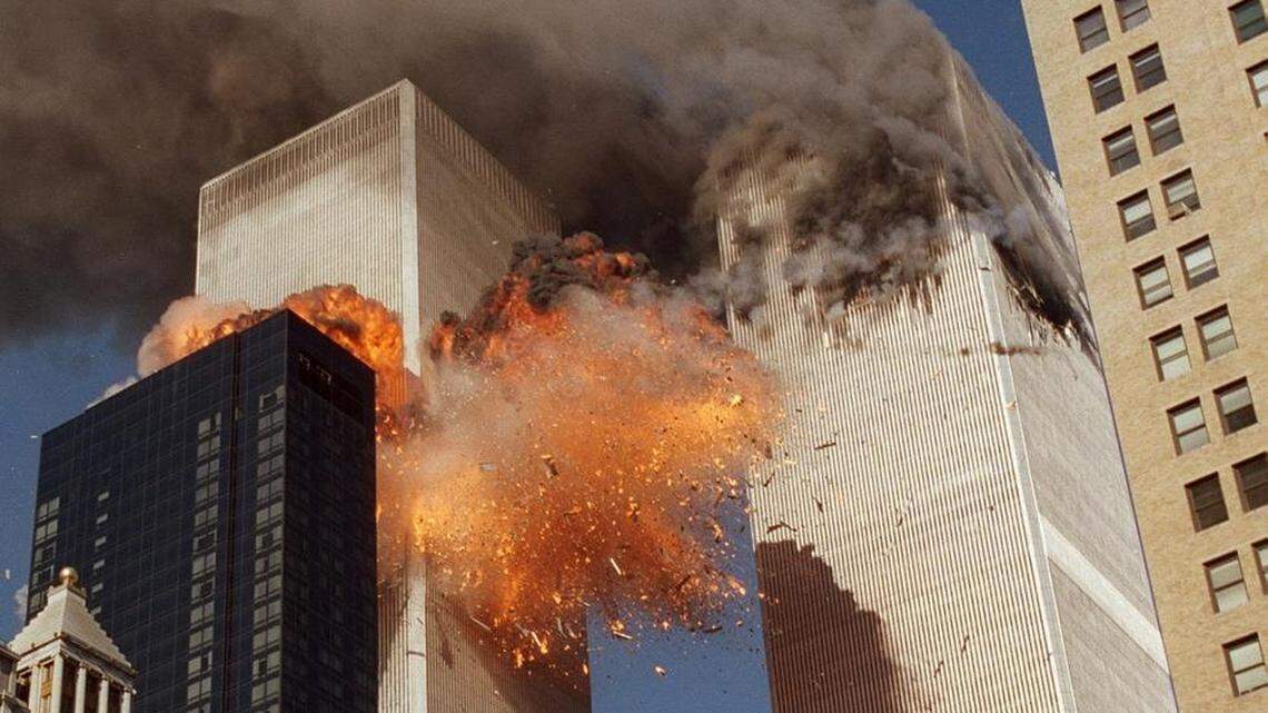 Smoke billows from one of the towers of the World Trade Center and flames and debris explode from the second tower, Tuesday, Sept. 11, 2001.