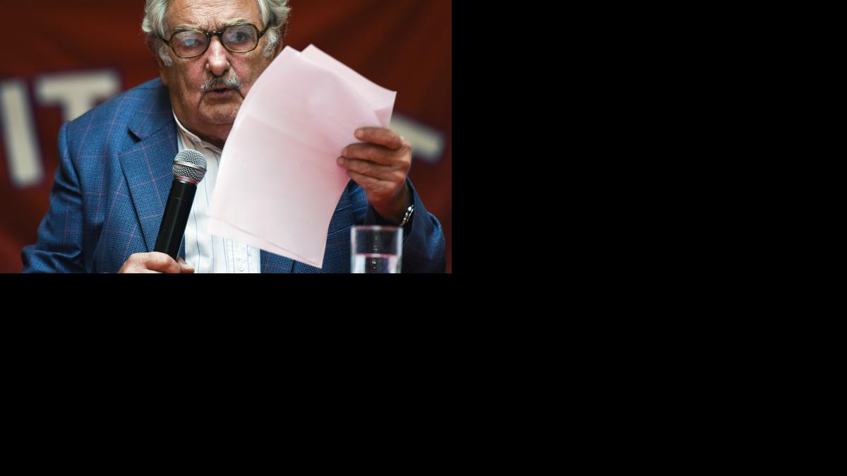 
Uruguay's President Jose Mujica reads a document during a press conference at the workers union PIT-CNT in Montevideo, Uruguay, Tuesday, Dec. 16, 2014. Mujica says the United States has guaranteed that six former Guantánamo Bay prisoners who arrived in Uruguay as refugees are not terrorists. He showed a document from the U.S. State Department saying there's no information that “the men were involved in conducting or facilitating terrorist activities” against the United States, its partners or allies. Members of Uruguay's opposition had requested the release of the documents. 
