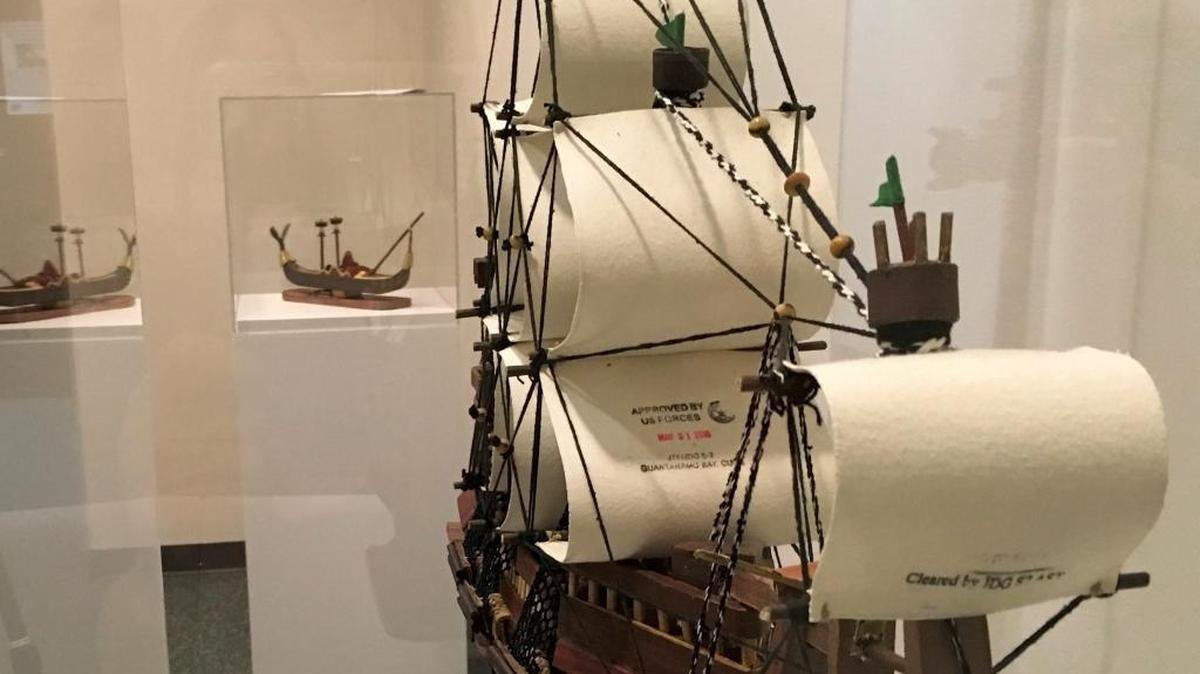 The prison at Guantánamo Bay, Cuba, put its stamp of approval for release on the sail of this model ship built by Yemeni captive Moath al Alwi from paper and other found objects at the Camp 6 communal prison for low value detainees. It was on display on Oct. 25, 2017 at the John Jay College of Criminal Justice as part of an exhibit of art made at the prison by captives past and present.