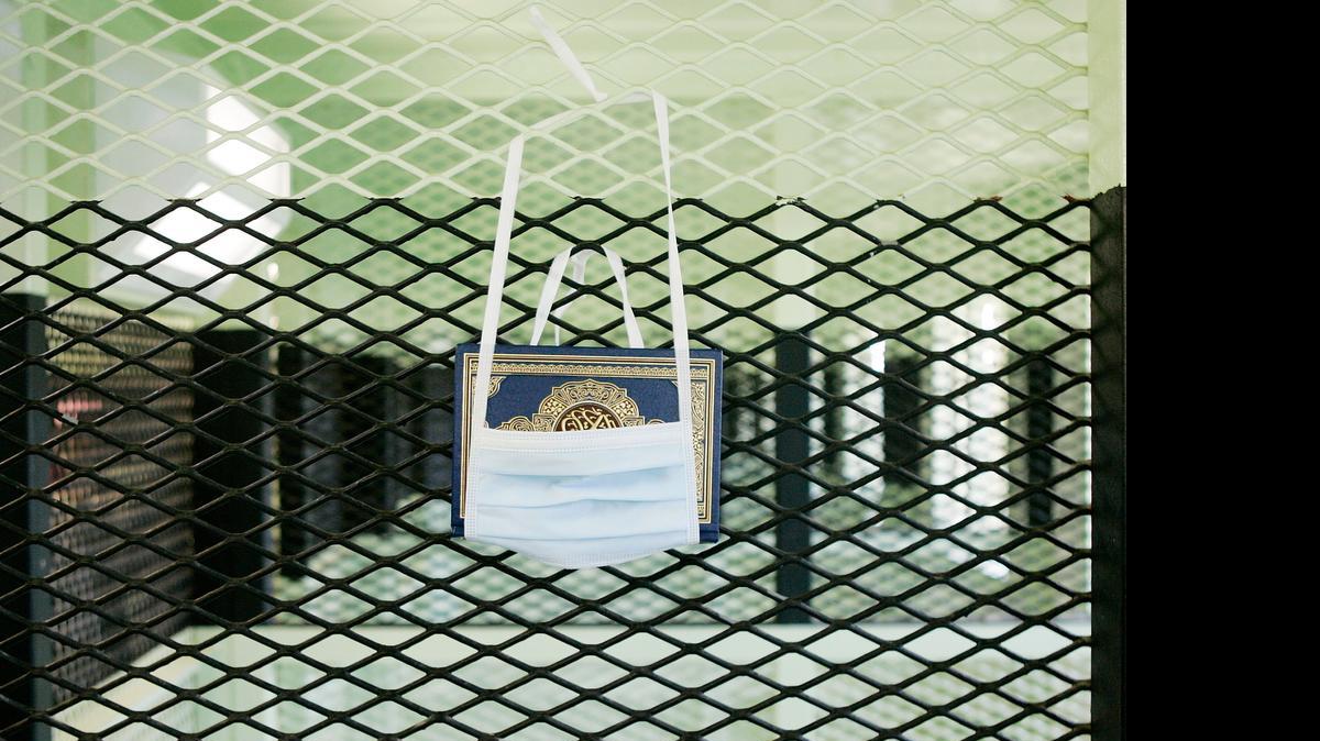
In an open air, now defunct portion of Camp Delta, the U.S. military displayed a sample captive’s Quran in a surgical mask rig for safekeeping in this May 9, 2006 photo approved for release by the U.S. military at the U.S. Navy base at Guantánamo Bay, Cuba.


