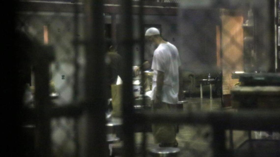 A detainee stands in the common area of the cell block on Saturday morning, Feb. 11, 2017 at Camp Six at Guantánamo’s Detention Center Zone. The military approved release of this photo.