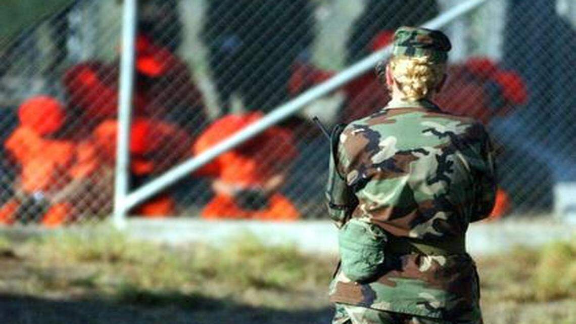 
Women soldiers have guarded Guantánamo captives from the very first day. In this photo, taken the day the first detainees arrived, Jan. 11, 2002, Private First Class Jodi Smith, an MP, stands perimeter watch at Camp X-Ray, the Pentagon’s first war-on-terror detention facility at the Navy base in Cuba.
