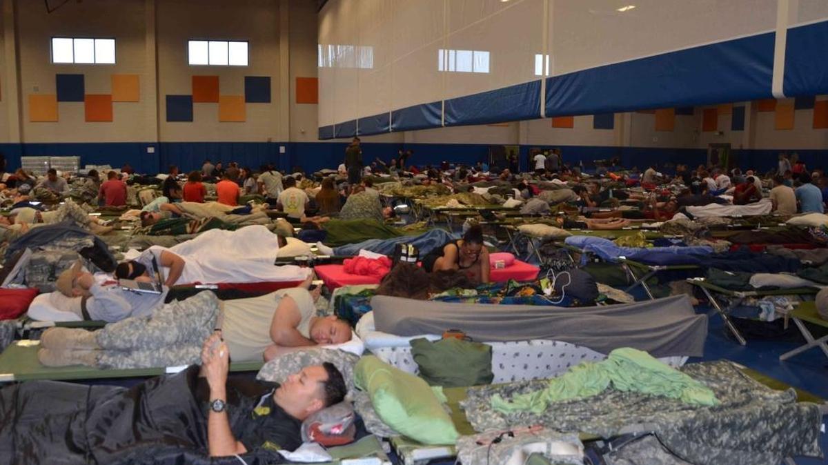 Guantánamo prison staff evacuated from trailer-park housing camped out Tuesday Oct. 4, 2016 in the base gym, far from the Detention Center Zone at the remote U.S. Navy base in Cuba, as shown in this Pentagon handout photo.