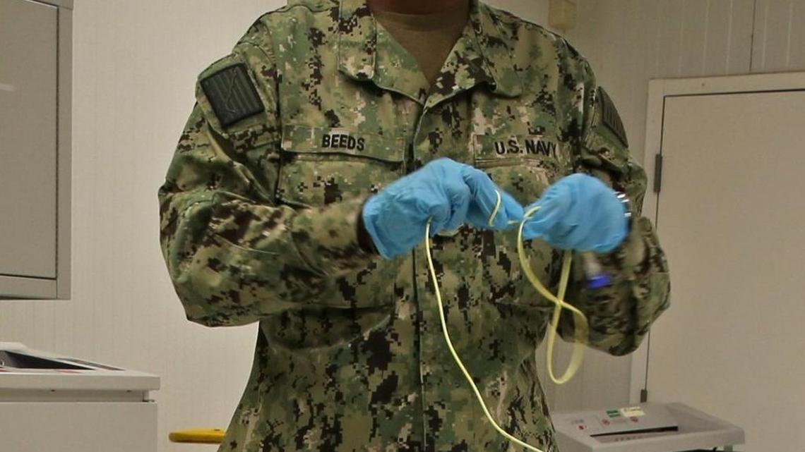 A Navy nurse explains how she inserts a tube into a hunger striker’s stomach at the U.S. Navy base at Guantánamo Bay, Cuba, on Tuesday, Nov. 4, 2014 in this photo approved for release by the U.S. military.
