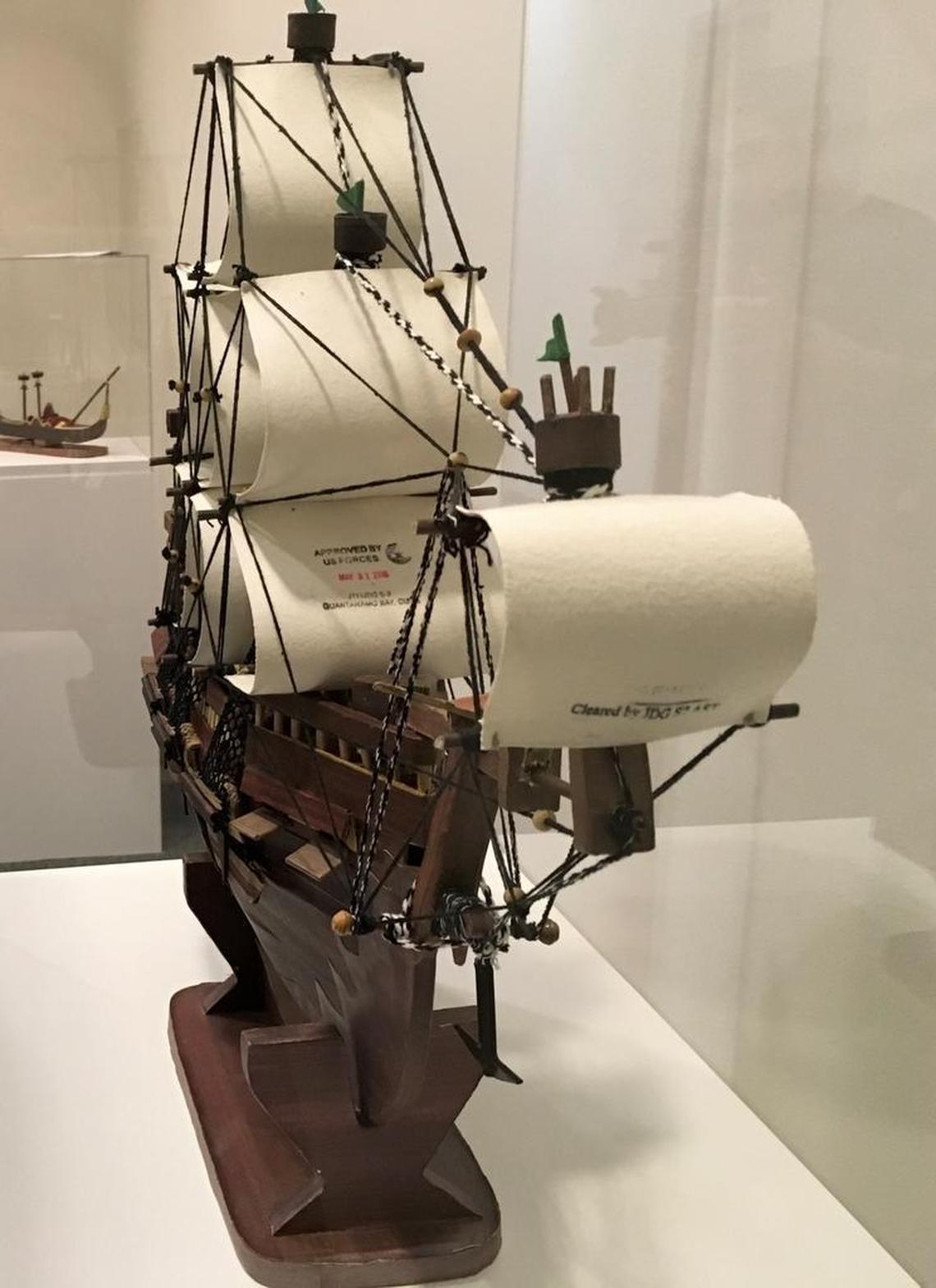 Guantánamo prison put its stamp of approval for release on the sail of this model ship built by a current captive, Yemeni Moath al Alwi. He made it from discarded paper and other objects, and gave it to his lawyer as a gift. Here it was on display on Oct. 25, 2017, at the John Jay College of Criminal Justice in midtown Manhattan.
