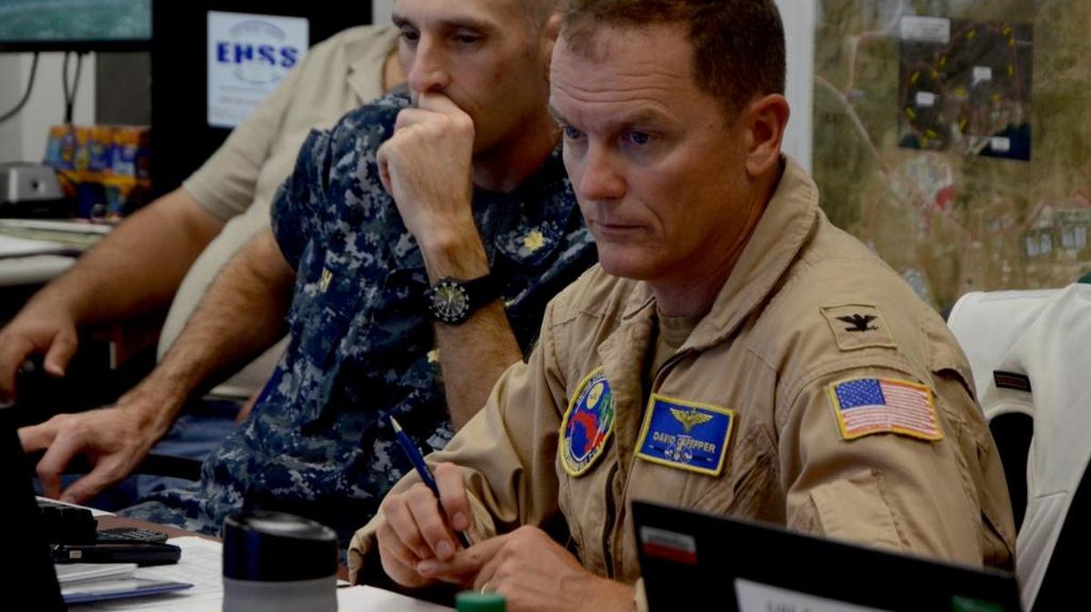 Commanding Officer Navy Capt. David Culpepper listens to a brief regarding Hurricane Matthew in the Emergency Operations Center at Guantánamo on Oct. 3, 2016 in this photo released by the base.