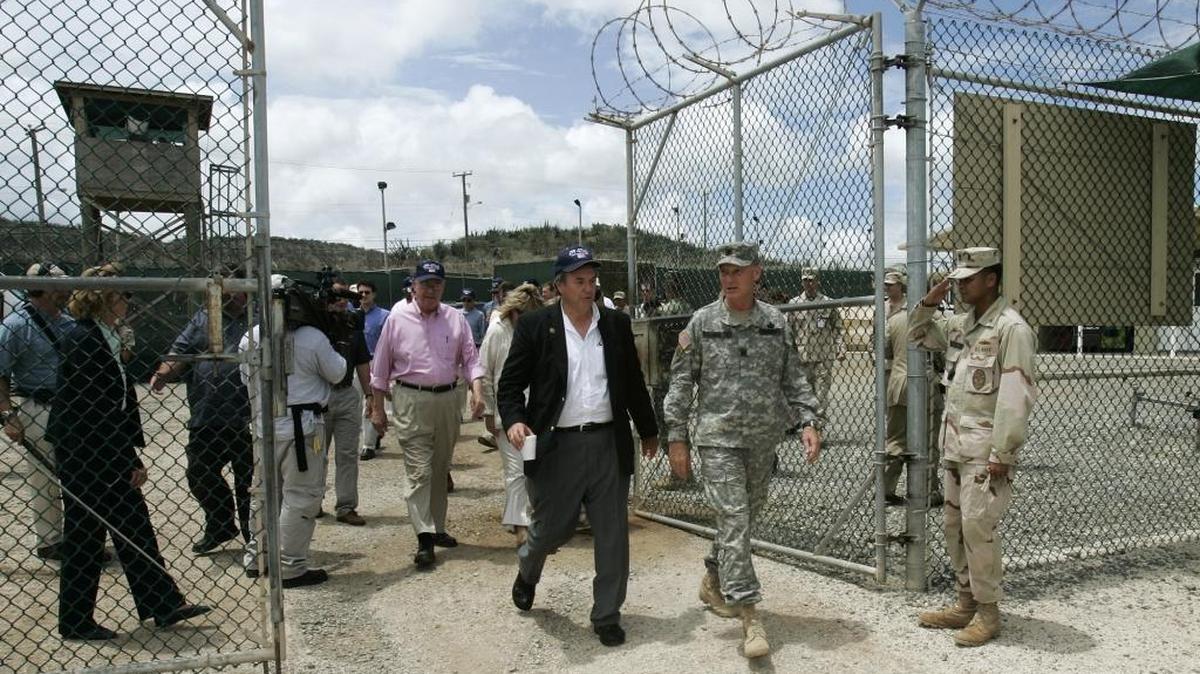 In this image reviewed by the U.S. military, then Army Brig. Gen. Jay Hood as commanding general of Joint Task Force Guantánamo escorts a Congressional delegation into Camp Delta, Saturday, June 25, 2005 at the U.S. Navy base in Cuba.